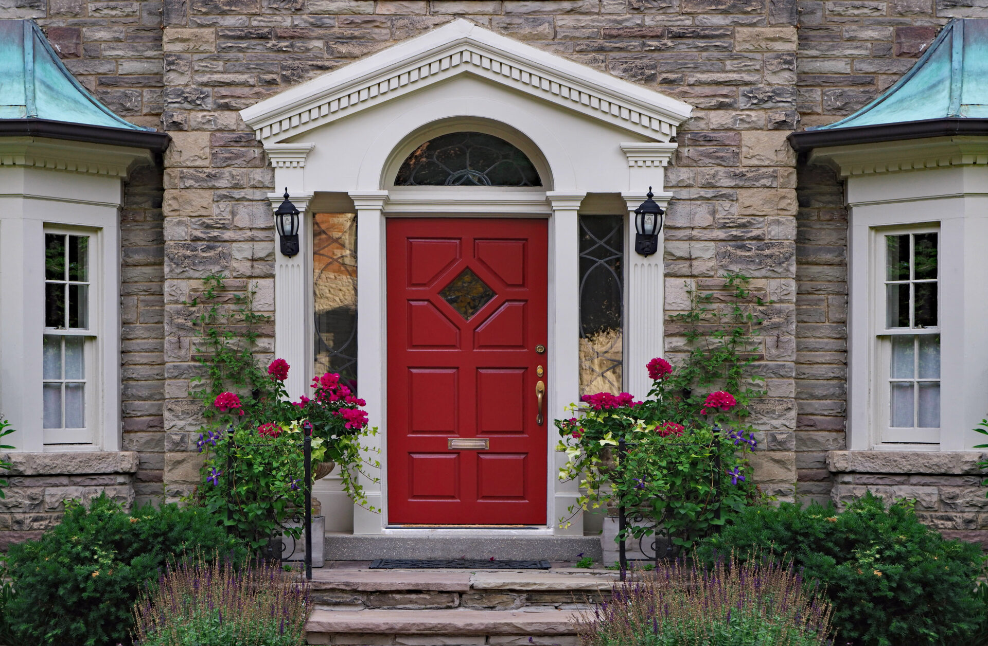front door of stone house with flowers